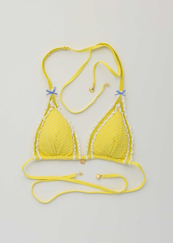 Yellow bikini set on a light gray background